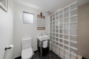 a bathroom with a toilet and a sink at Terrace Vila by An Island Apart in Caniço +19 photos