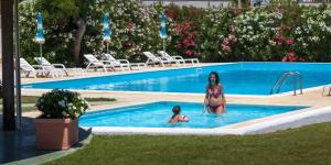 a woman and a child in a swimming pool at Residence Club Barbara in Ostuni
