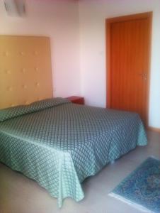 - une chambre avec un lit et une porte en bois dans l'établissement Agriturismo la Chioccia, à Campagna Lupia