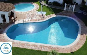 an overhead view of a large swimming pool in a yard at Sunny Vilamoura Pool Apartment- Free Parking- Fiber Wi-Fi in Vilamoura