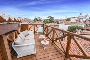 a balcony with a white chair and a table at Ca' Dell'Opera Terrace - Dimora Italia - in Venice