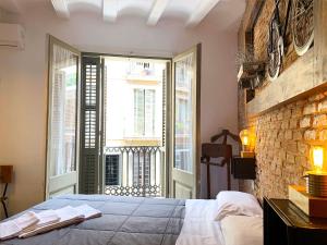 a bedroom with a bed and a brick wall at Hostal Portugal in Barcelona