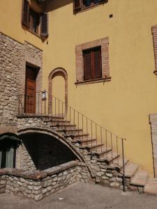 a building with a stone staircase and a bridge at Sulle orme di Francesco appartamento verde in Bastia Umbra