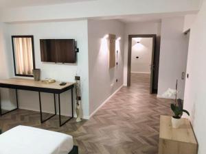 a room with a bed and a table and a hallway at Hotel Lido in Durrës