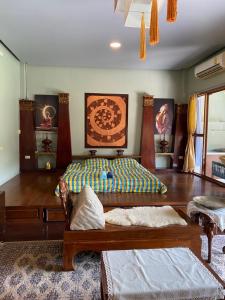 a bedroom with a bed and a table and chairs at Viewdoi Art and Resort in Ban Buak Khang
