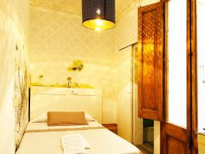 Posteľ alebo postele v izbe v ubytovaní Hostal Portugal