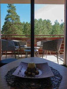 a table with a plate of food on top of a balcony at Apartman Relax Lux - Vila Peković in Zlatibor