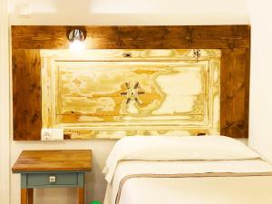a bedroom with a bed and a wooden wall at Hostal Portugal in Barcelona