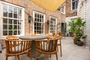 an outdoor patio with a table and chairs at HARBOR HOUSE ZEELAND - nl in Goes