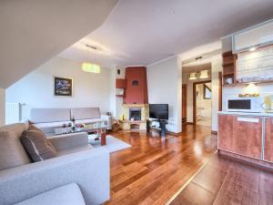 a living room with a couch and a fireplace at VisitZakopane - Amber Apartment in Zakopane