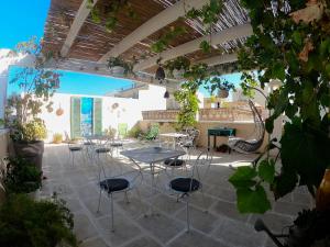a patio with chairs and tables in a courtyard at Palazzo Cesare - Monopoli in Monopoli