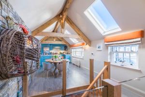 a kitchen and dining room with a vaulted ceiling at Wella 5 Star Gold Award Luxury Cottage in St Ives