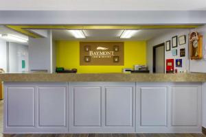 a bar in a dental office with a yellow wall at Baymont by Wyndham Marinette in Marinette