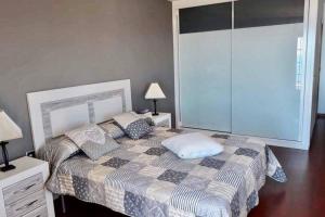 a bedroom with a bed with a pillow on it at APPARTEMENT PENISCOLA Espagne in Peniscola