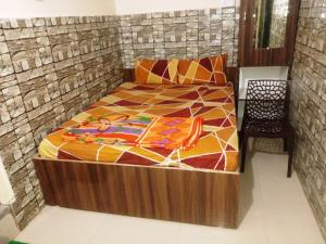 a bed with a wooden frame in a room at Budget Hotel in Patna +45 photos