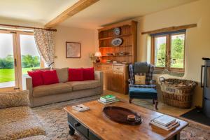 a living room with a couch and a table at Yew Tree Cottage in Shepton Mallet