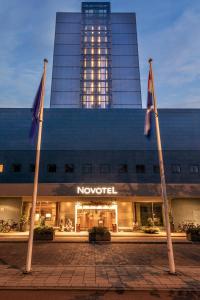 
a large building with a flag on top of it at Novotel The Hague World Forum in The Hague
