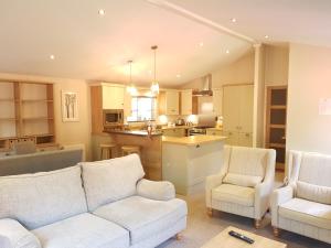 a living room filled with furniture and a kitchen at St. Ives Holiday Village in St Ives