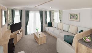 a living room with a couch and a tv at St. Ives Holiday Village in St Ives