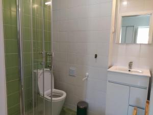 a bathroom with a toilet and a sink at Urban Apartment in Faro