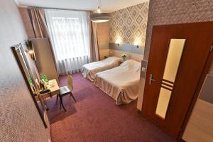 Łóżko lub łóżka w pokoju w obiekcie Hotel Kazimierz