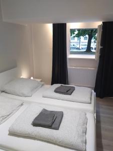 two beds in a room with two towels on them at City-Apartment Spreeufer im Herzen Berlins in Berlin