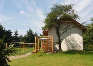 a small house with a tree in the yard at Apartamenty-Obok in Zator