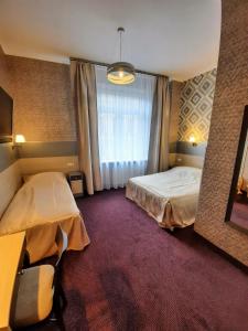 Łóżko lub łóżka w pokoju w obiekcie Hotel Kazimierz