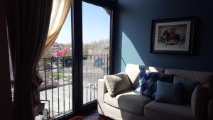 a living room with a couch and a large window at La Rotonda in Pavia