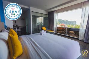 Łóżko lub łóżka w pokoju w obiekcie Wake Up Aonang Hotel