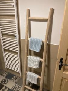 a wooden towel rack in a bathroom with towels at Haus Poxleitner in Mauth