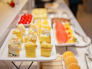 a buffet of different types of sandwiches and fruit at Lavande Hotel (Changsha Railway Station Branch) in Changsha