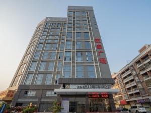 a tall building with a sign in front of it at Lavande Hotel Zhongshan Nanlang Light Rail Station in Zhongshan
