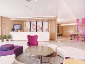 a lobby with purple and white chairs and a table at Lavande Hotel Ningbo Railway Station North Square in Ningbo