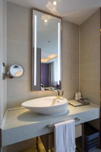 a bathroom with a large sink and a mirror at Lavande Hotel (Changsha City Government Branch) in Changsha