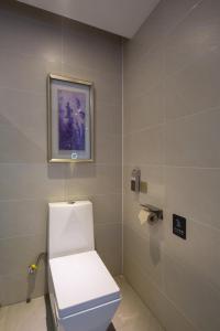a bathroom with a toilet and a picture on the wall at Lavande Hotel (Changsha City Government Branch) in Changsha
