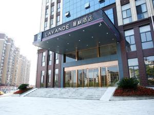 a large building with a staircase in front of it at Lavande Hotel Jiujiang Jiujiang College in Jiujiang