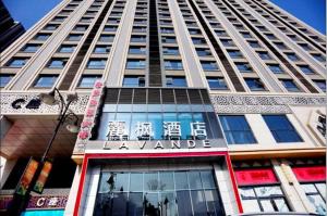 a tall building with a sign on the front of it at Lavande Hotel Yinchuan Wanda International Convention and Exhibition Center in Yinchuan