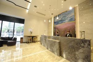 a lobby with a large painting on the wall at Lavande Hotel Changde Railway Station Branch in Changde