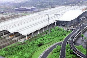 an airport with a building with white roofs and a road at Lavande Hotel Xuzhou West Exit of High Speed Rail Station Branch in Xuzhou