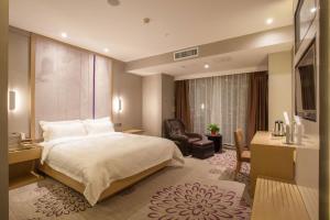 a hotel room with a bed and a desk and a chair at Lavande Hotel Xuzhou West Exit of High Speed Rail Station Branch in Xuzhou