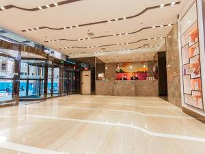 a lobby of a building with wooden floors and ceilings at Lavande Hotel Zhangjiakou Victoria Plaza in Zhangjiakou