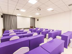 Pokój z purpurowymi biurkami i białymi krzesłami w klasie w obiekcie Lavande Hotel Jinzhong Yuci Walmart Branch w mieście Jinzhong