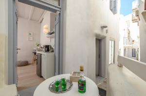 a room with a white table with bottles on it at Venetian Suites in Naxos Chora