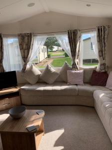 a living room with a couch and a table at Seton sands static holiday home - sleeps 6 in Port Seton