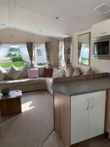 a living room with a couch and a table in a room at Seton sands static holiday home - sleeps 6 in Port Seton