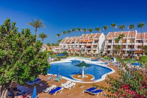 an image of a resort with a swimming pool and palm trees at Parque Santiago 2 - Playa de Las Américas Tenerife in Arona