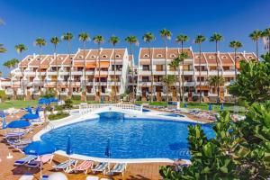 an image of a resort with a swimming pool and palm trees at Parque Santiago 2 - Playa de Las Américas Tenerife in Arona