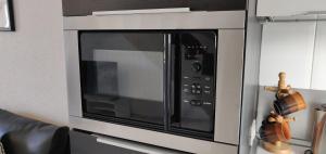 a microwave oven sitting on top of a wall at Parque Santiago 2 - Playa de Las Américas Tenerife in Arona