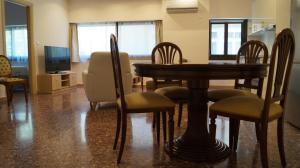 a dining room with a table and chairs and a television at Luxury Apartment in Plaka - Acropolis (Lavender) in Athens